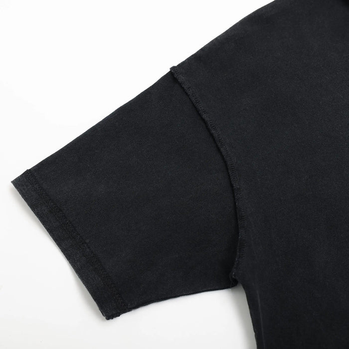 Black T-shirt sleeve hem close-up with stitched cuff