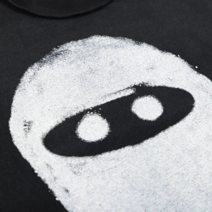 White ninja eye sketch graphic on black T-shirt