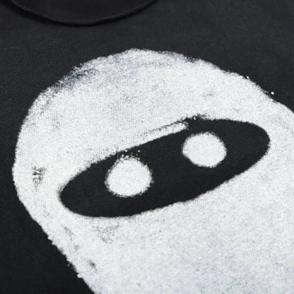 White ninja eye sketch graphic on black T-shirt