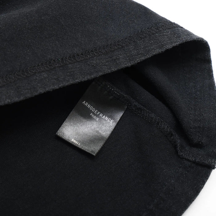 Black T-shirt with interior brand neck label and ribbed collar