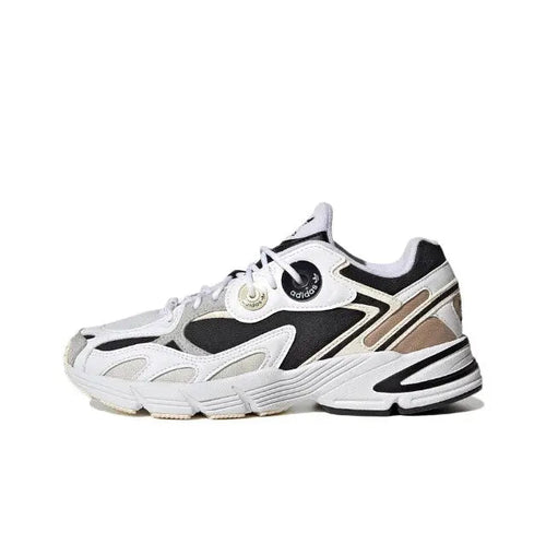 White and black lace-up sneakers with cream accents and chunky striped sole