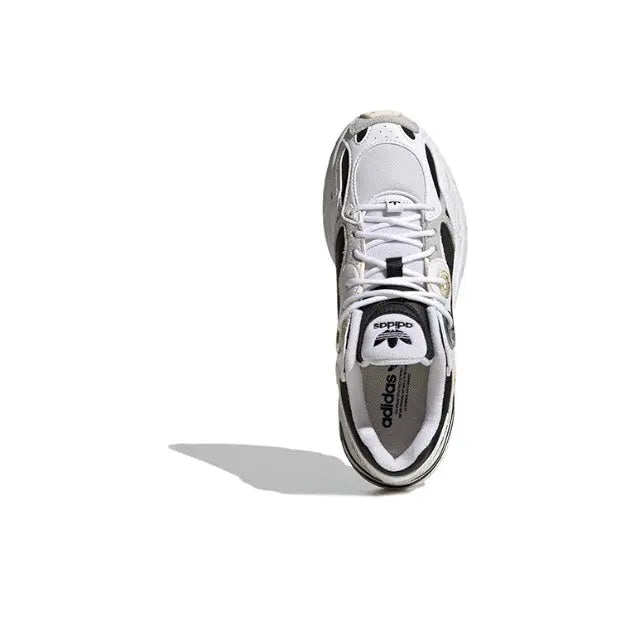 White lace-up sneaker with black side panel and Adidas logo on the tongue