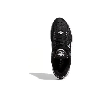 Black low-top sneakers front view with lace-up closure and cushioned tongue