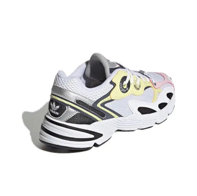 Adidas Astir sneaker heel and side, white upper with black stripes and yellow panel.