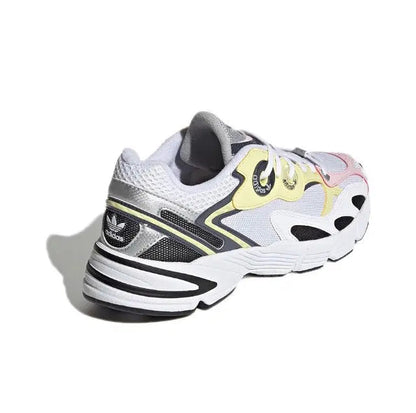 Adidas Astir sneaker heel and side, white upper with black stripes and yellow panel.