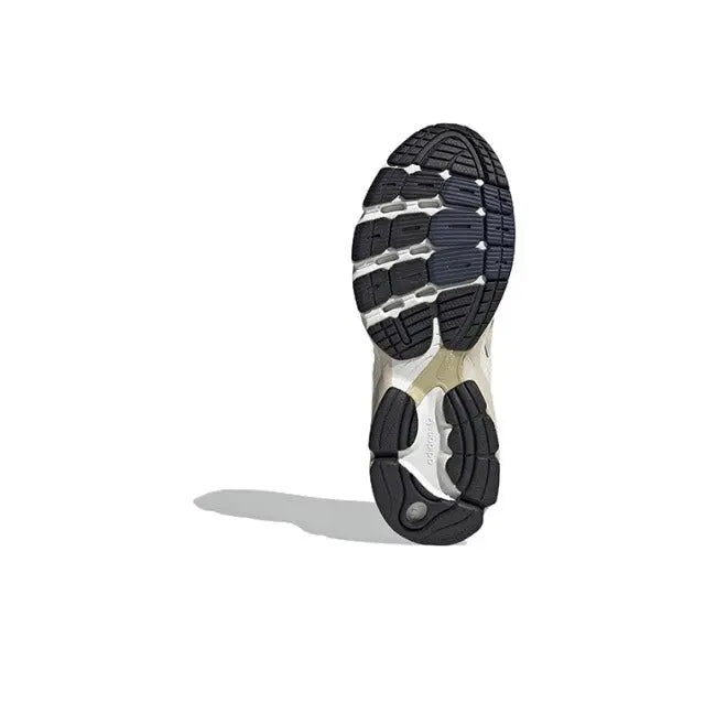 Shoe outsole for cream and gold lace-up sneaker, black tread pattern and white midsole