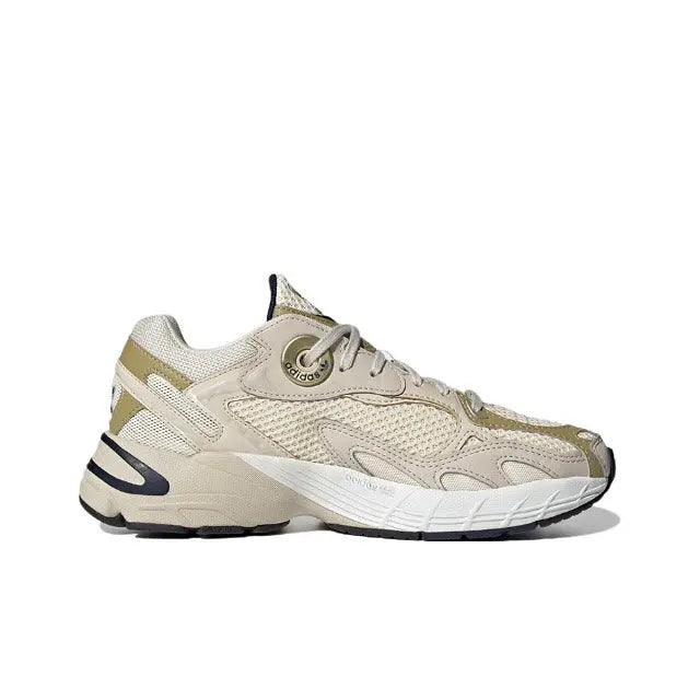 Cream lace-up sneaker with light-gold detailing, textured uppers, navy heel and stripes
