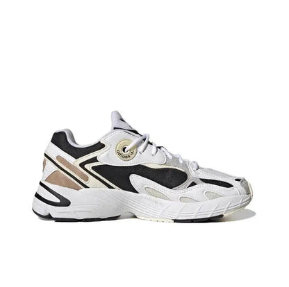 White lace-up sneakers with black and tan stripes and thick ribbed midsole