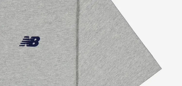 Grey athletic T-shirt sleeve with small New Balance logo
