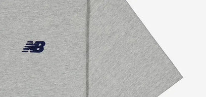 Grey athletic T-shirt sleeve with small New Balance logo