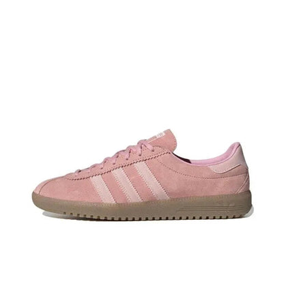 Pink low-top sneakers with three-stripe side panel and lace-up closure, gum sole