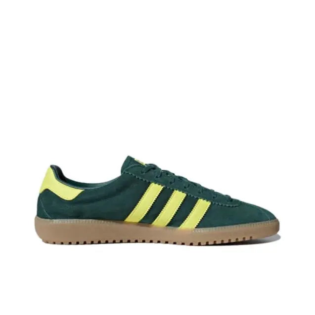 Low-top sneakers dark green with yellow three stripes and lace-up closure; gum sole
