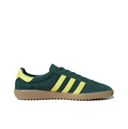 Low-top sneakers dark green with yellow three stripes and lace-up closure; gum sole