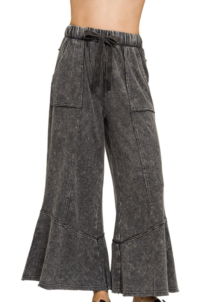 Dark lounge pants with elastic drawstring waist, side pockets, wide flare hem
