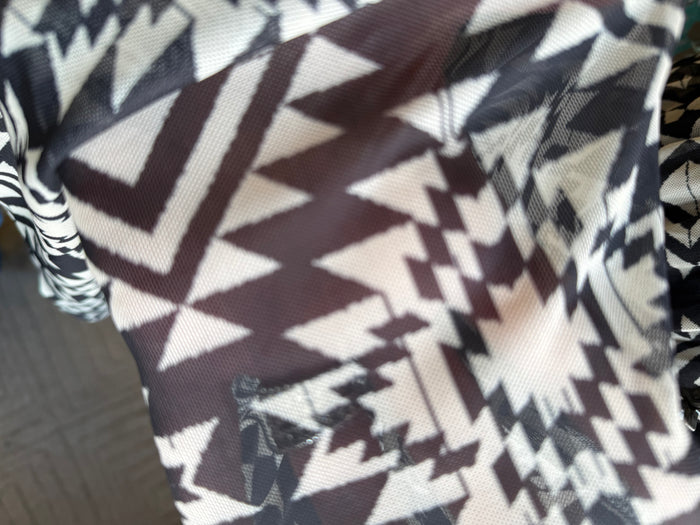 Black and white aztec geometric fabric panel, close-up