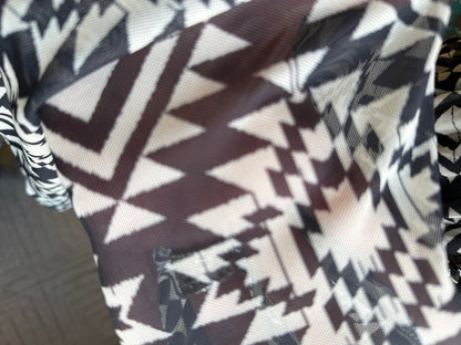 Black and white aztec geometric fabric panel, close-up