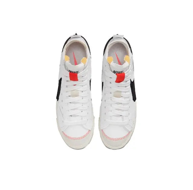 White Nike Blazer sneakers with red accents, lace-up and mesh tongue