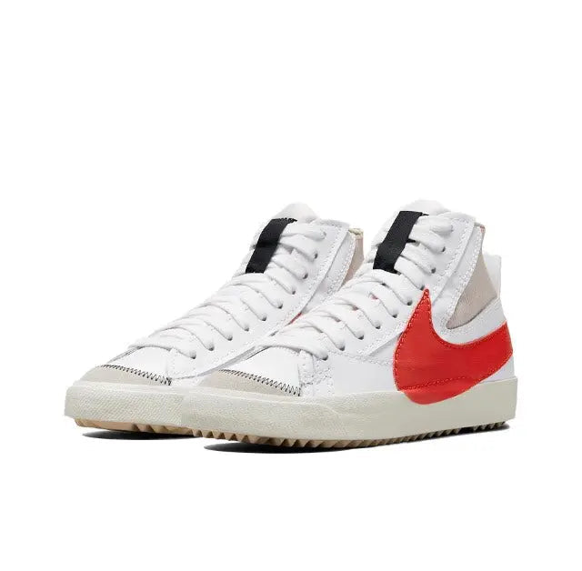 High-top sneakers with white upper, beige ankle panel, red Nike swoosh, black heel tabs