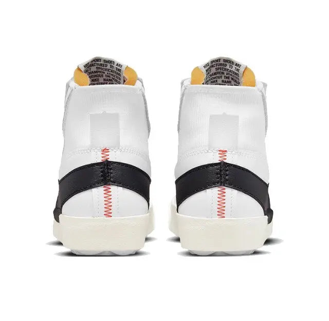 White and black Nike Blazer sneakers with red heel stitch detail