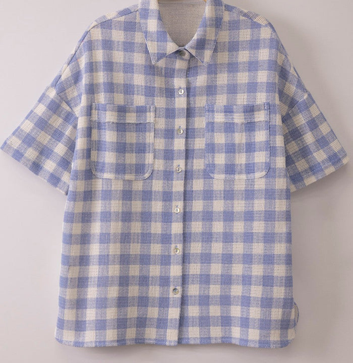 Blue and white checked button-front shirt with short sleeves and chest patch pockets