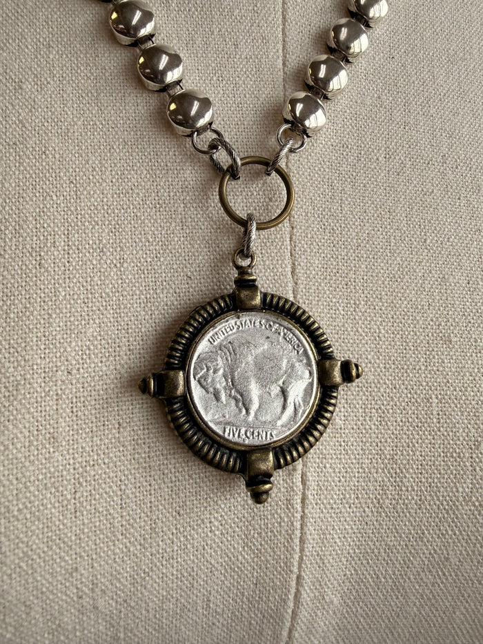 Brass coin disc necklace with antique-style round coin medallion pendant detail