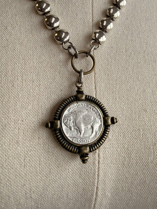 Brass coin disc necklace with antique-style round coin medallion pendant detail