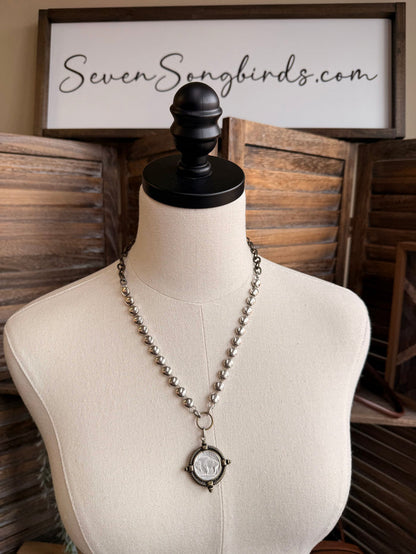 Brass coin disc necklace on a mannequin with round coin pendant and bead chain