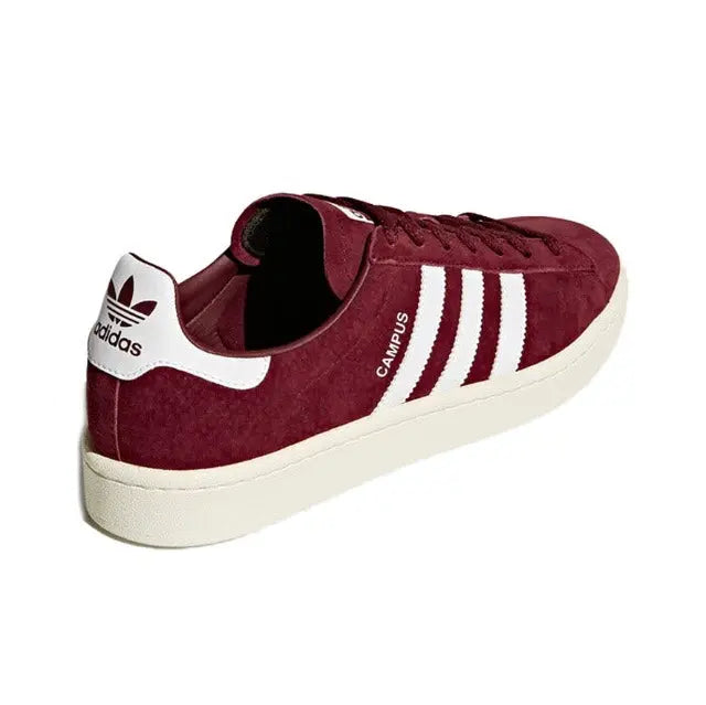 Burgundy suede Adidas Campus sneakers with white stripes and adidas heel tab