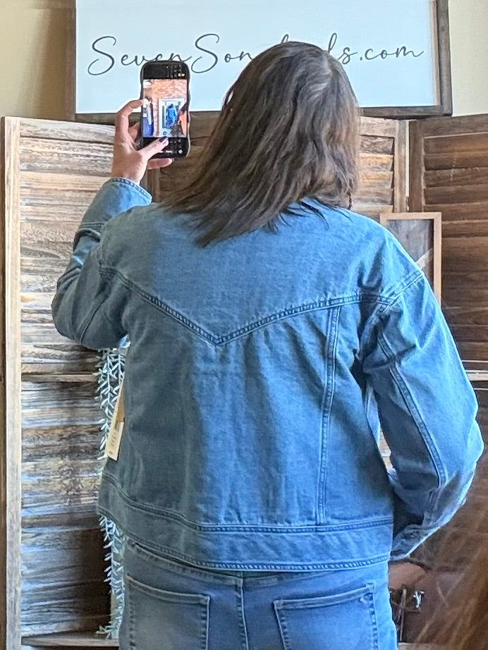 Blue denim jacket with button front and yoke, shown from the back