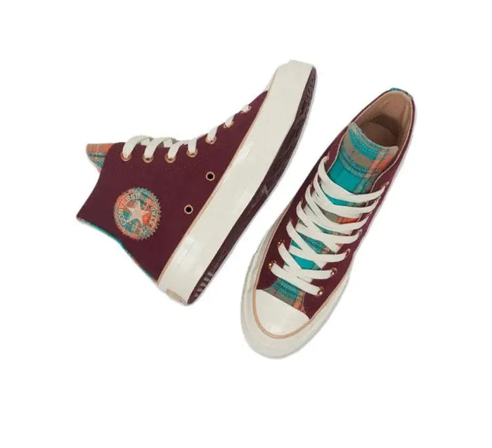 Converse 1970's high-top sneakers pair, wine-red uppers with multicolor laces