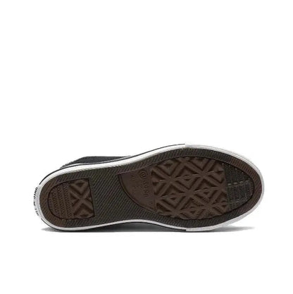 Black canvas sneaker outsole with textured tread and white midsole edge.