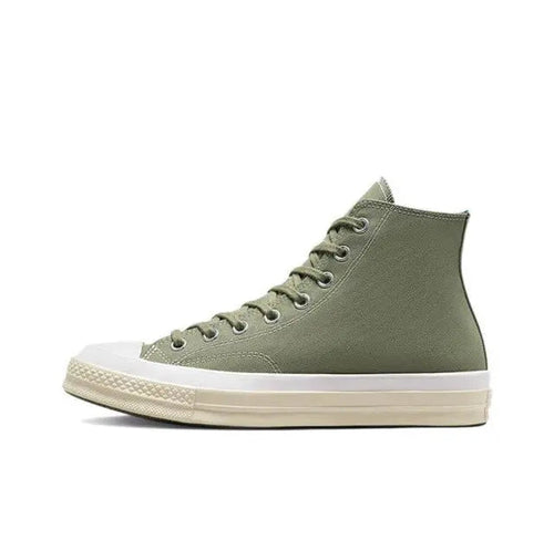 Olive green mid-top canvas sneaker with lace-up eyelets and white rubber sole