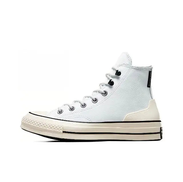 Light blue high-top sneakers with black laces and cream sole, side view