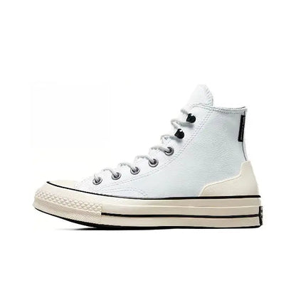 Light blue high-top sneakers with black laces and cream sole, side view