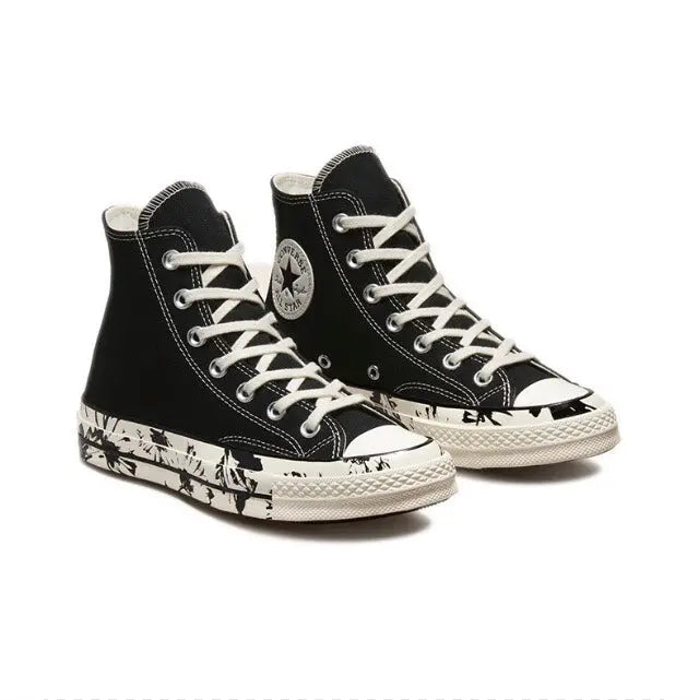Pair of black high-top canvas sneakers with white laces and patterned midsole