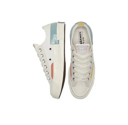 Low-top sneakers side and tongue view, white canvas with multicolor side stripe