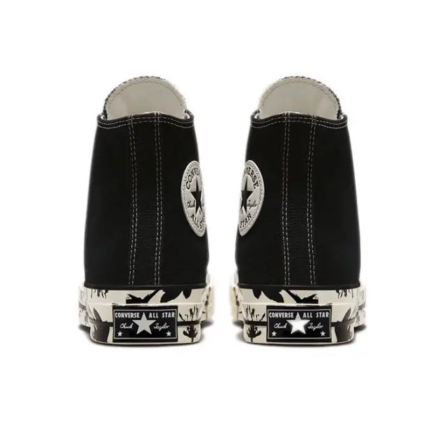 Black high-top canvas sneakers with rear All Star patch and patterned toe cap