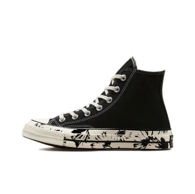 Black high-top canvas sneaker with white laces and splatter print midsole
