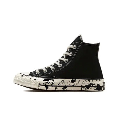 Black high-top canvas sneaker with white laces and splatter print midsole