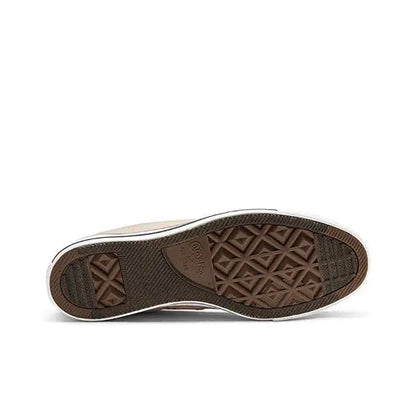 High-top sneaker outsole with brown rubber tread and geometric pattern