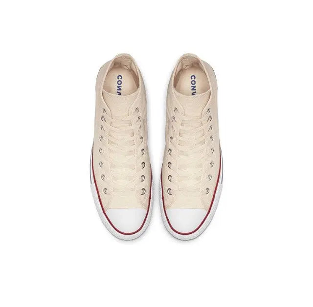 Beige canvas sneakers with lace-up, red-trim toe and white sole