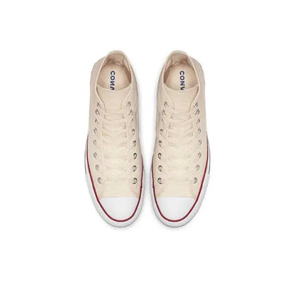 Beige canvas sneakers with lace-up, red-trim toe and white sole