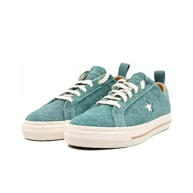Pair of light blue suede low-top sneakers with star logo and white rubber sole