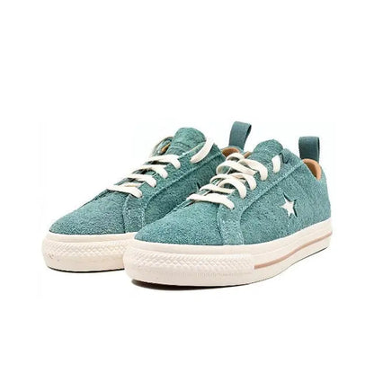 Pair of light blue suede low-top sneakers with star logo and white rubber sole