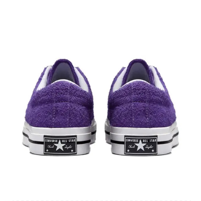 Purple low-top sneakers with white rubber toe caps and heel branding patch