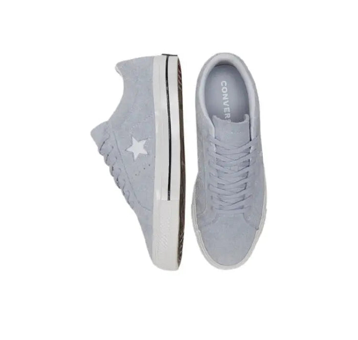 Light grey low-top sneakers pair with visible tongue interior label