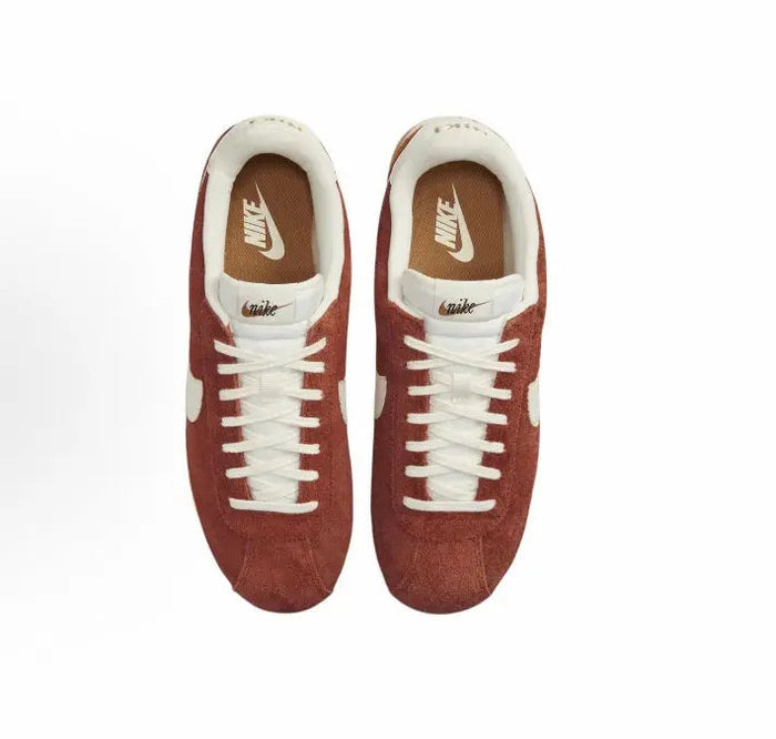 Cortez SE sneaker pair, dark russet suede uppers with white laces and Swoosh
