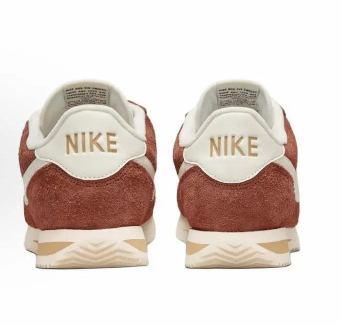 Cortez SE sneaker backs, Nike logo on white heel with dark russet suede