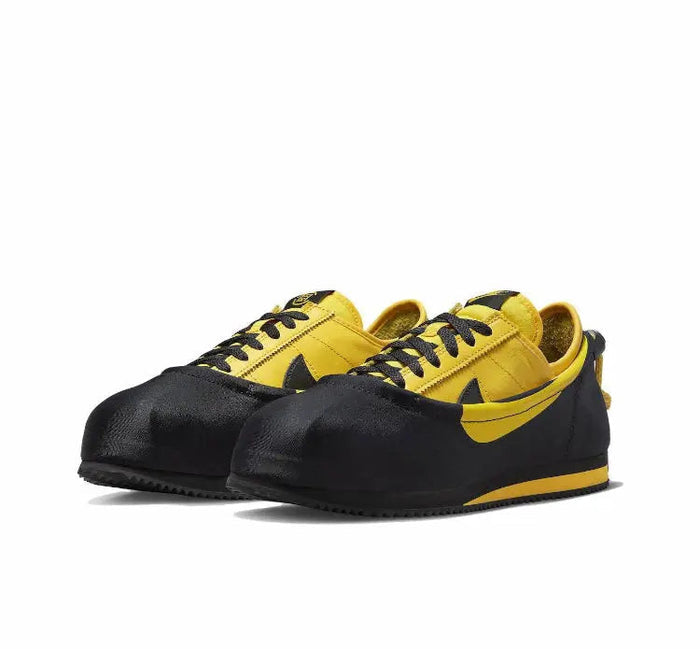 Low-top sneakers, black and yellow, front pair view with lace eyelets