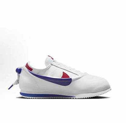Nike Cortez x Clot sneakers, side view in white with blue swoosh and red quarter panel
